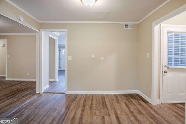 interior space with crown molding, a wealth of natural light, and hardwood / wood-style flooring