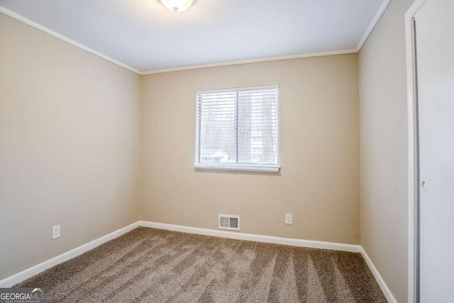 empty room with ornamental molding and carpet