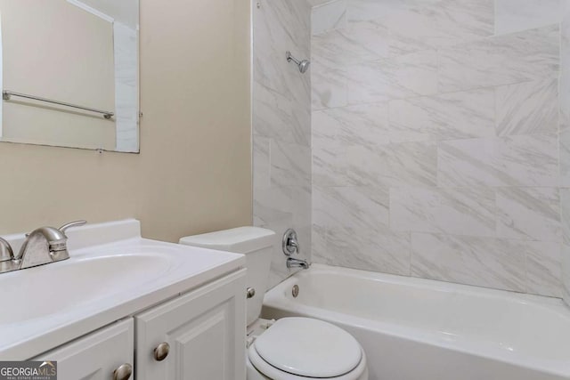 full bathroom with tiled shower / bath combo, vanity, and toilet