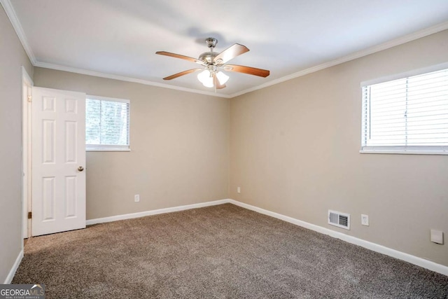 carpeted spare room featuring crown molding and ceiling fan