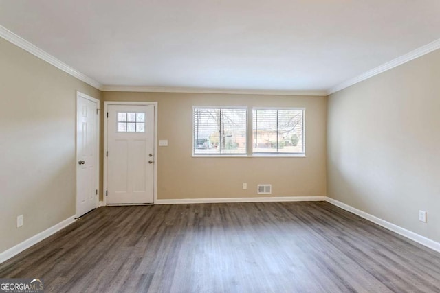 entrance foyer featuring crown molding and dark hardwood / wood-style floors