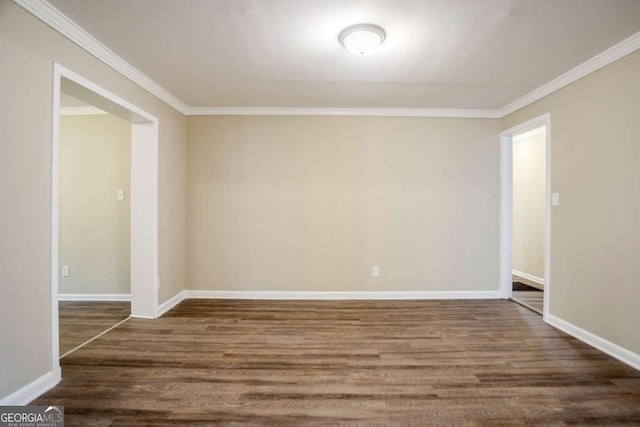 empty room with dark wood-type flooring and crown molding