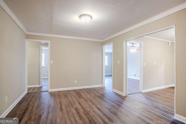 spare room featuring hardwood / wood-style flooring and ornamental molding