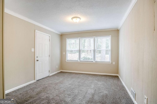 unfurnished room with ornamental molding, carpet flooring, and a textured ceiling