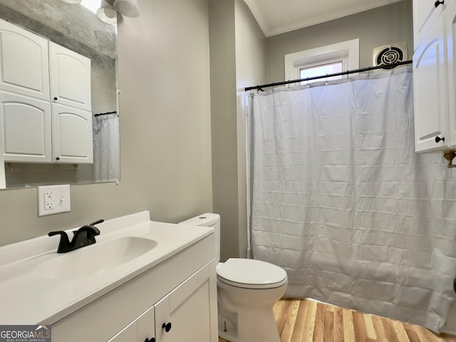 bathroom with a shower with curtain, ornamental molding, vanity, and toilet
