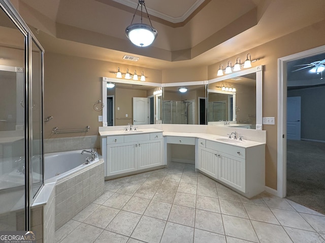 bathroom with crown molding, vanity, a tray ceiling, tile patterned floors, and independent shower and bath