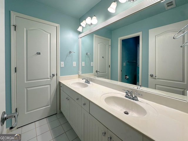 bathroom with tile patterned flooring and vanity