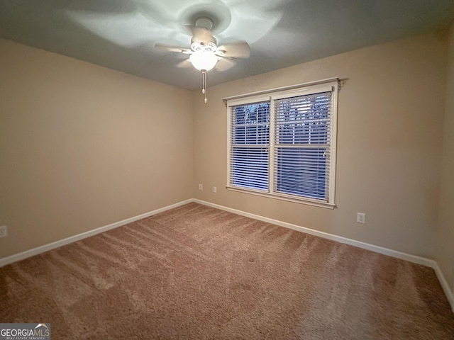 empty room with ceiling fan and carpet