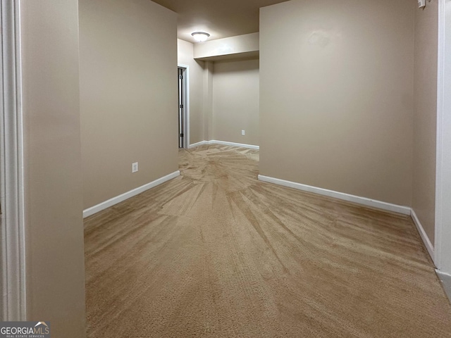 unfurnished room featuring light carpet