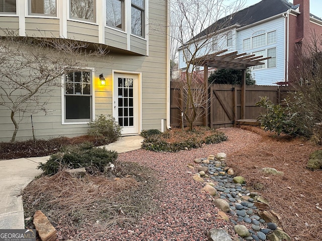 property entrance with a pergola