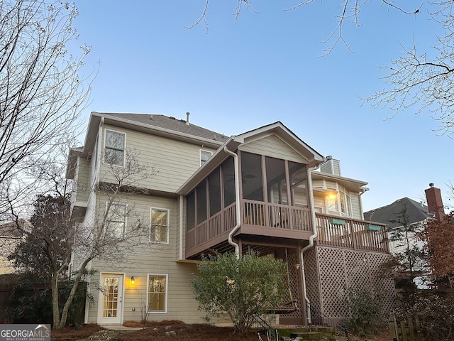 rear view of house with a sunroom