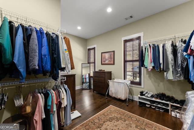 spacious closet with dark hardwood / wood-style flooring