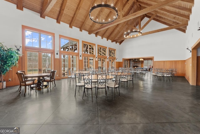 dining room featuring french doors, high vaulted ceiling, wooden ceiling, a notable chandelier, and beamed ceiling