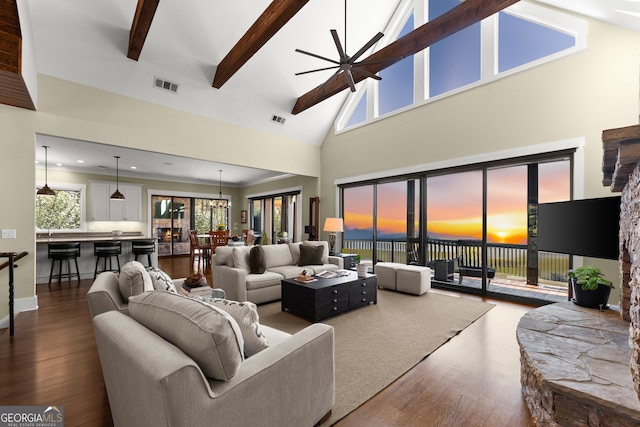 living room with beamed ceiling, wood-type flooring, ceiling fan, and high vaulted ceiling