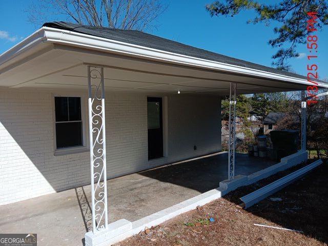 view of exterior entry with a carport