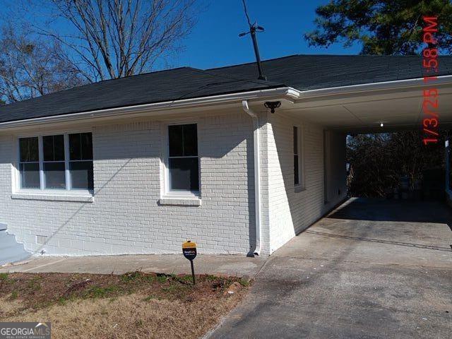 view of home's exterior featuring a carport