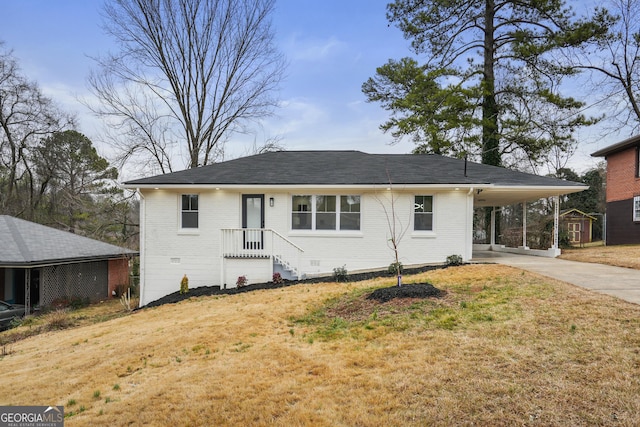 view of front facade with a carport and a front yard