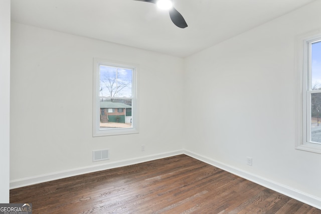 empty room with ceiling fan and dark hardwood / wood-style floors