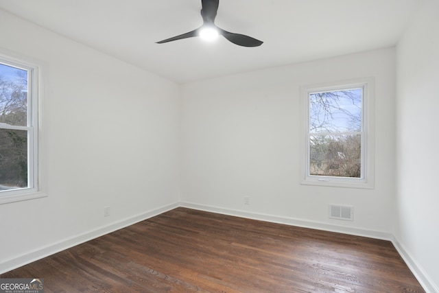 spare room featuring ceiling fan and dark hardwood / wood-style floors