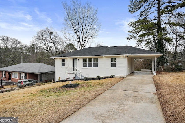 view of front of property with a front lawn and a carport