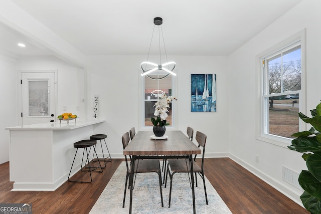 dining room featuring dark hardwood / wood-style floors and a chandelier