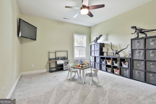 recreation room with ceiling fan and light carpet