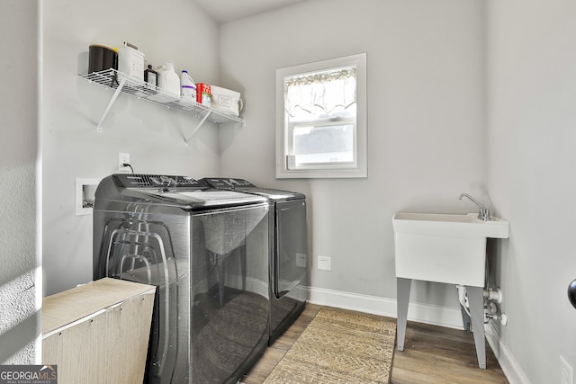 washroom featuring washer and dryer and light wood-type flooring