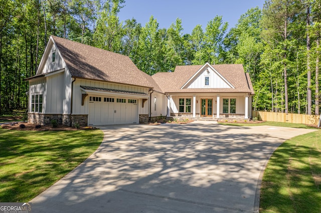 view of front of home with a garage and a front lawn