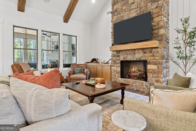 living room featuring a fireplace, lofted ceiling with beams, and wood finished floors