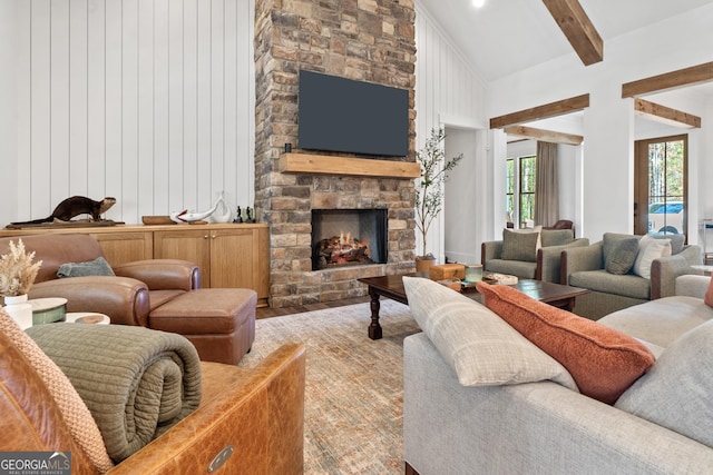 living room featuring high vaulted ceiling, beam ceiling, and a fireplace