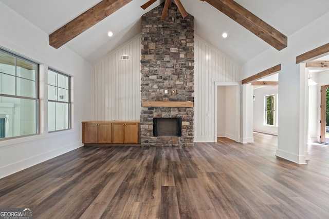 unfurnished living room with beamed ceiling, dark wood-style flooring, a fireplace, and high vaulted ceiling