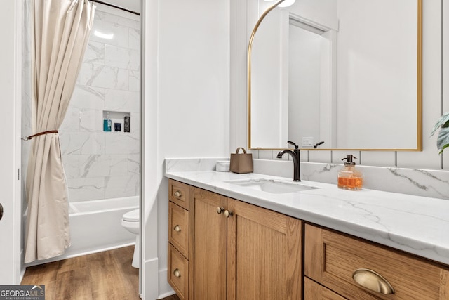 bathroom with toilet, shower / bathtub combination with curtain, vanity, and wood finished floors