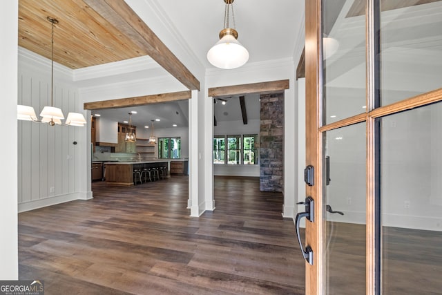 foyer entrance featuring baseboards, ornamental molding, dark wood finished floors, and beamed ceiling