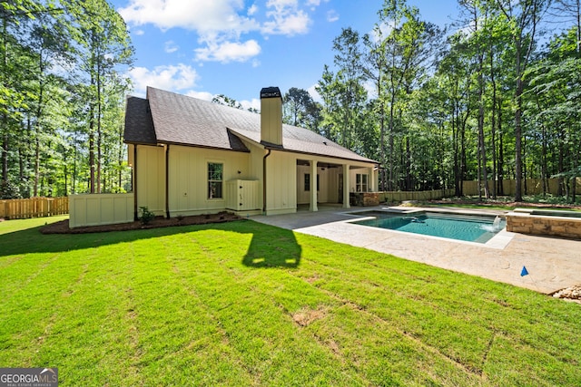 back of property with a patio area, a fenced backyard, board and batten siding, and roof with shingles