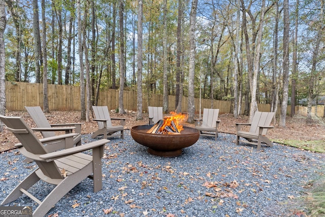 view of patio with an outdoor fire pit and fence