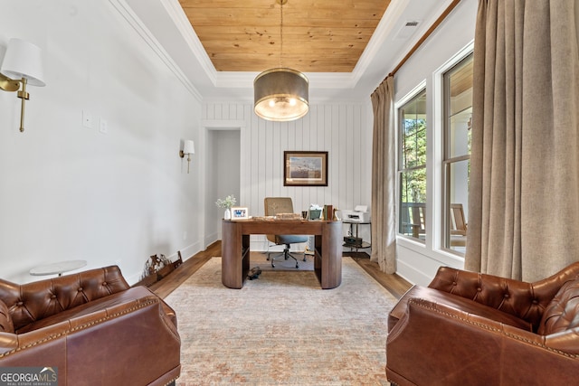 home office featuring a tray ceiling, crown molding, light wood-type flooring, wooden ceiling, and baseboards