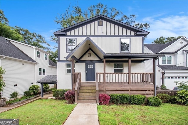 view of front of property with a garage, covered porch, and a front lawn