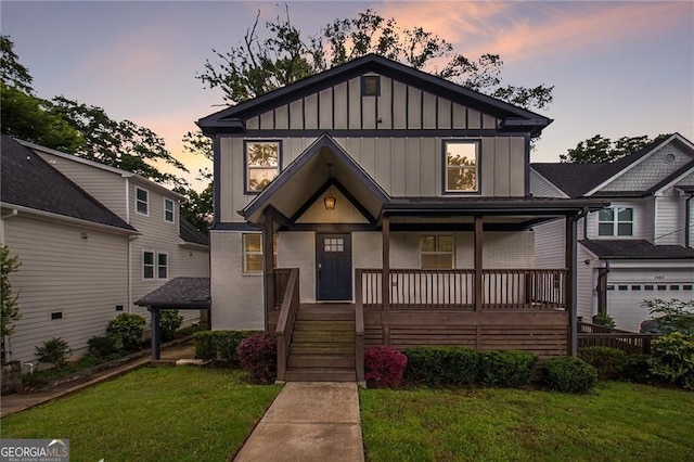 view of front of house featuring a porch and a yard