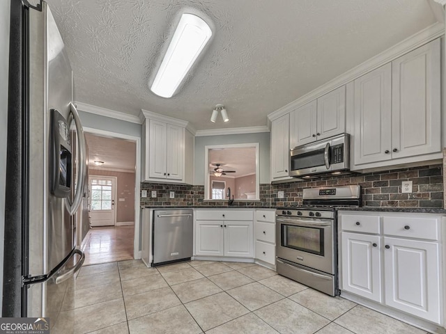 kitchen featuring white cabinetry, light tile patterned floors, and stainless steel appliances