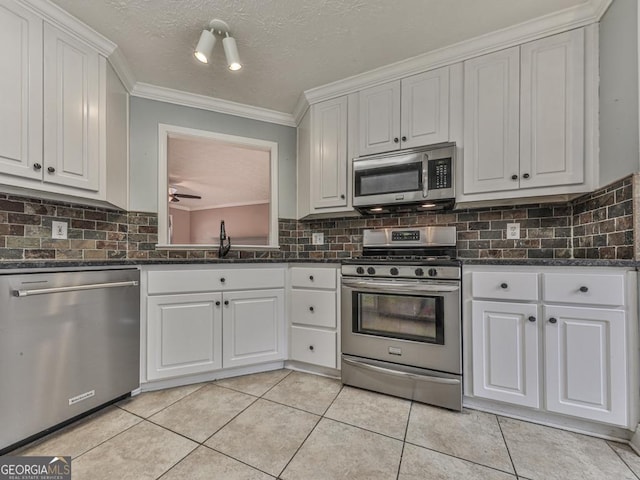 kitchen featuring white cabinetry, stainless steel appliances, sink, and light tile patterned floors