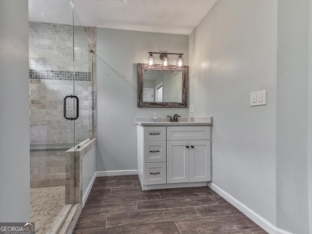 bathroom featuring an enclosed shower and vanity