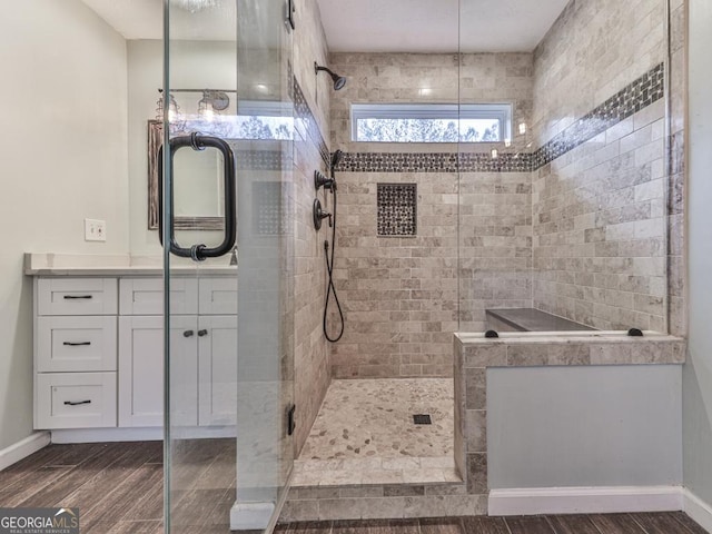 bathroom with vanity and a shower with door