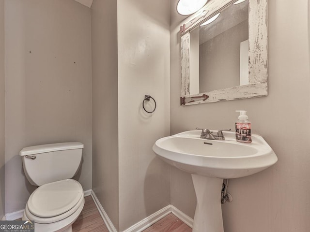 bathroom featuring toilet and hardwood / wood-style floors