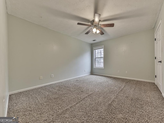 carpeted empty room featuring a textured ceiling and ceiling fan