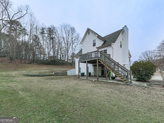 rear view of property with central AC, a yard, a deck, and a patio area