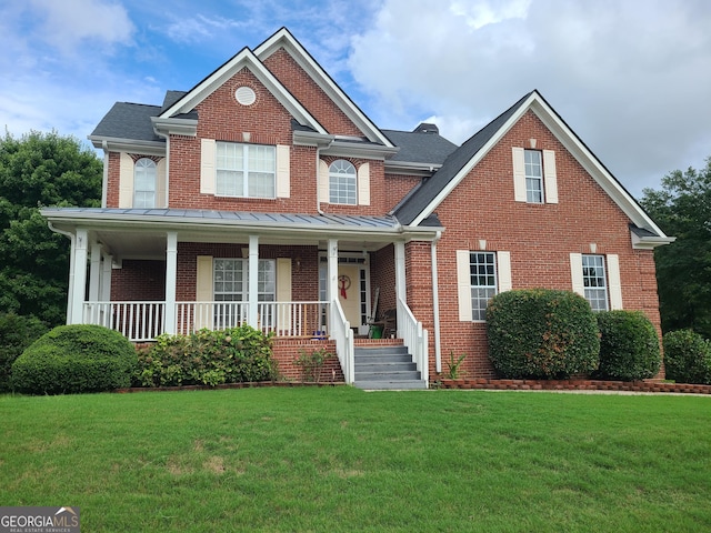 view of front of property featuring covered porch and a front yard