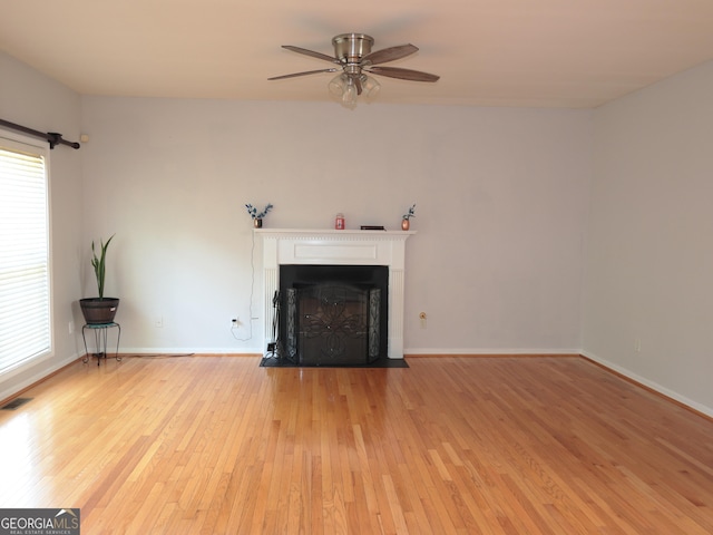 unfurnished living room featuring ceiling fan and light hardwood / wood-style flooring