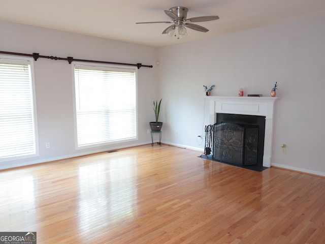 unfurnished living room featuring ceiling fan and light wood-type flooring