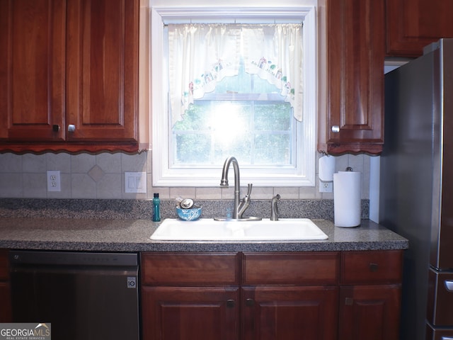 kitchen with dishwasher, sink, stainless steel fridge, and decorative backsplash