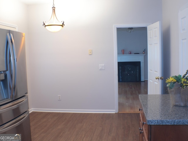 kitchen with decorative light fixtures, dark hardwood / wood-style floors, and stainless steel refrigerator with ice dispenser